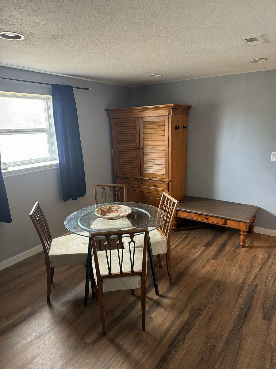 Entry way bench, dining room, and large cabinet for extra storage.