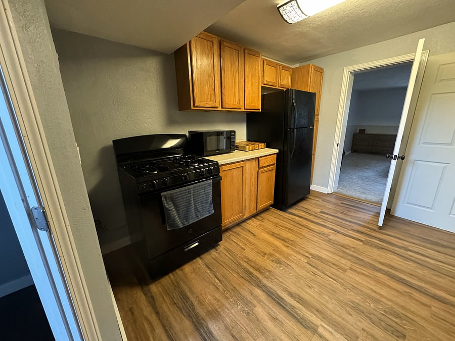 Full kitchen with oven, refrigerator, and microwave. There is also washer and dryer in the kitchen area.