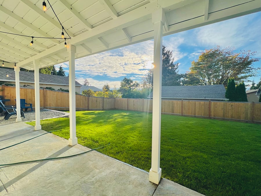 Fully-fenced backyard. Green grass is dependent on the season.