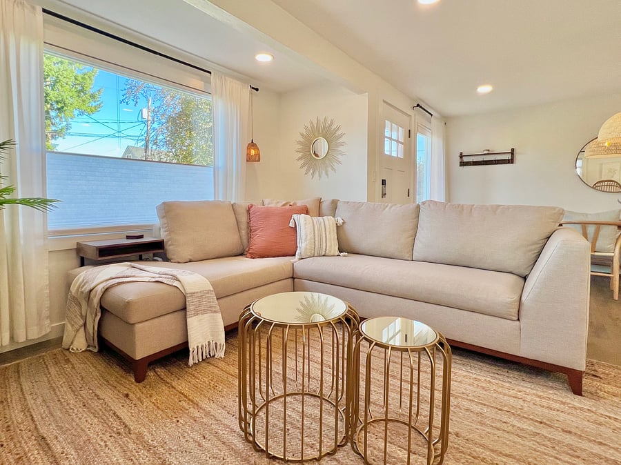 Living room with comfy L-shaped couch with chaise, smart Firestick TV, and high-speed internet