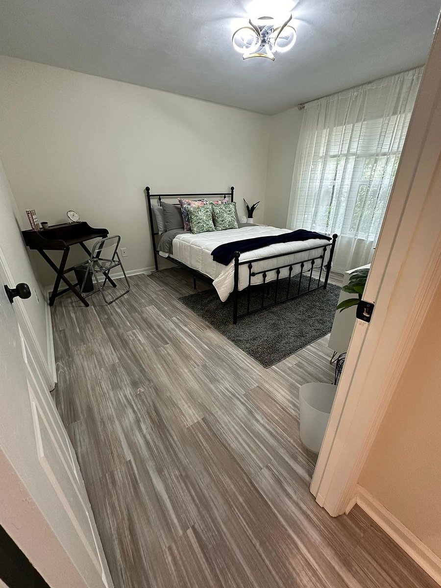 Discover comfort in our second bedroom! Featuring a cozy queen bed, TV for entertainment, ample storage with closet and drawers, a desk for remote work, and a mirror for your convenience. Rest and recharge in style!