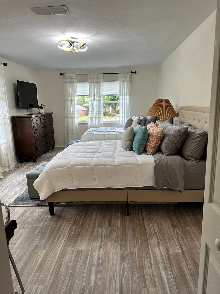 Welcome to our master bedroom oasis! Enjoy 2 queen beds, a spacious walk-in closet, en-suite bathroom, 50" TV, desk for work, and ample drawer space. Relax in comfort and style!