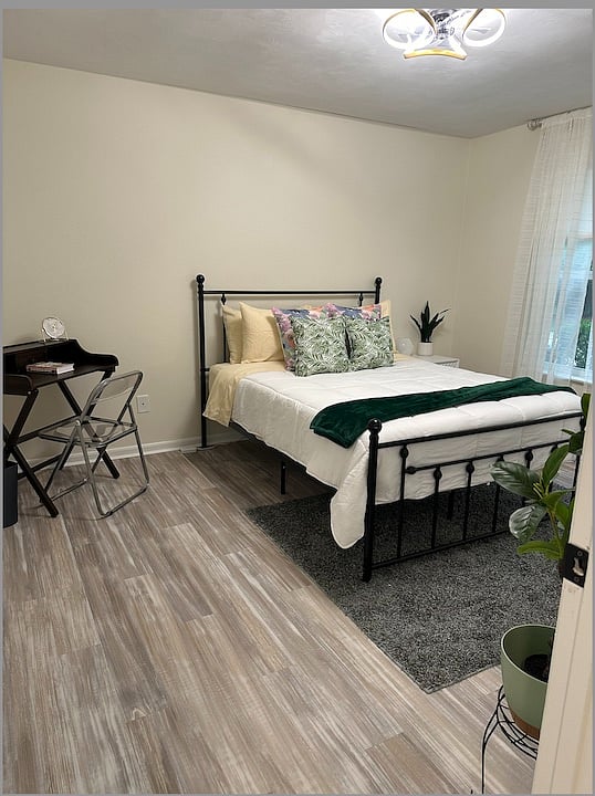 Discover comfort in our second bedroom! Featuring a cozy queen bed, TV for entertainment, ample storage with closet and drawers, a desk for remote work, and a mirror for your convenience. Rest and recharge in style!