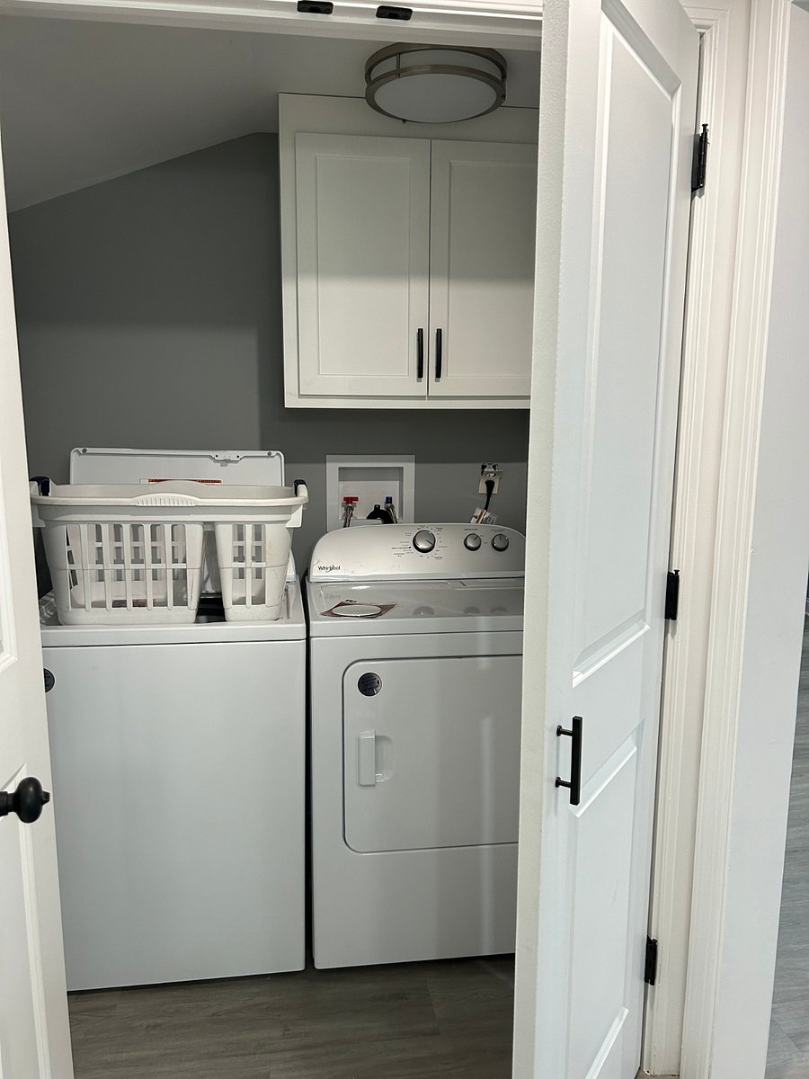Laundry room with new washer and dryer.