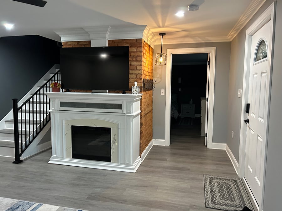 Coat rack at Entrance and staircase to second floor living area. Door to master bedroom