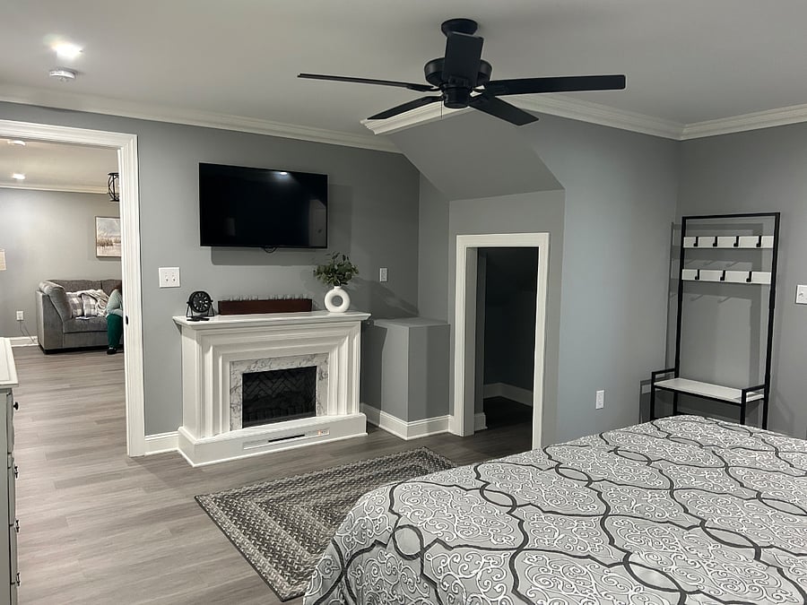 Master bedroom with electric fireplace and smart TV