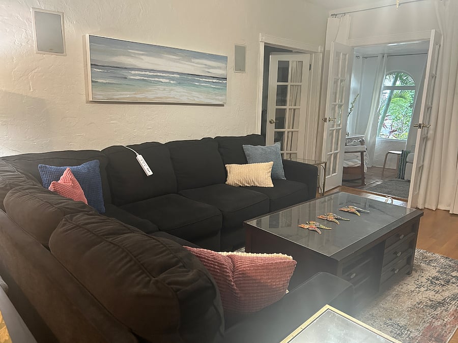Living room with view of front sunroom. Smart TV 55 inch