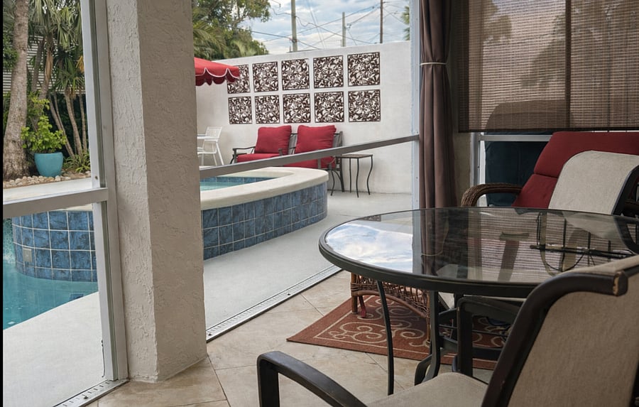 Patio overlooking pool with access from Primary bedroom 1 and bedroom 3. Perfect place for morning coffee and relaxing.