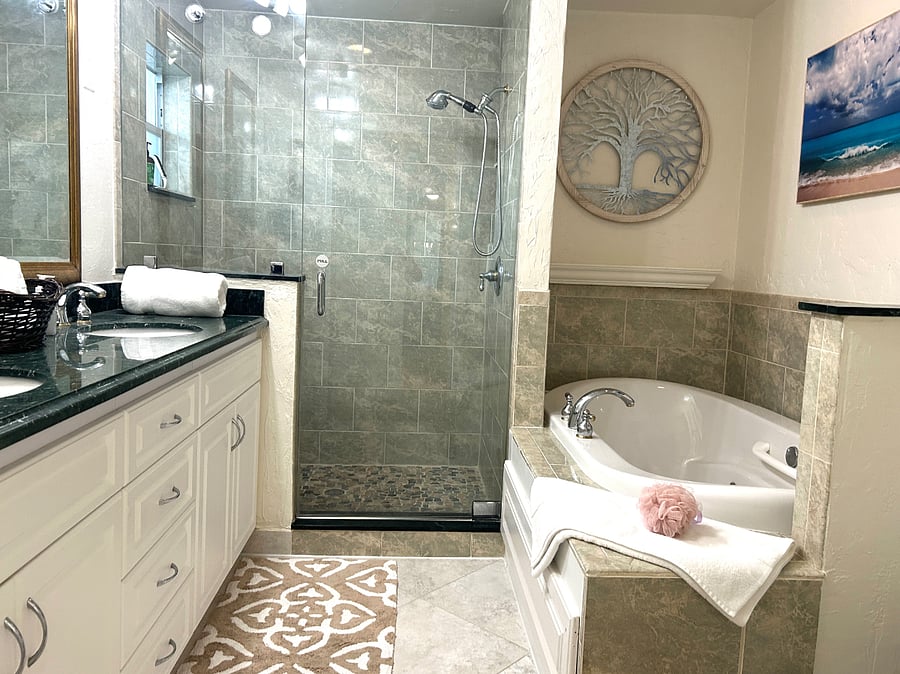 Primary bedroom 1 en-suite spa style bathroom with double sinks, large walk-in shower with glass enclosure, plus large spa tub.
