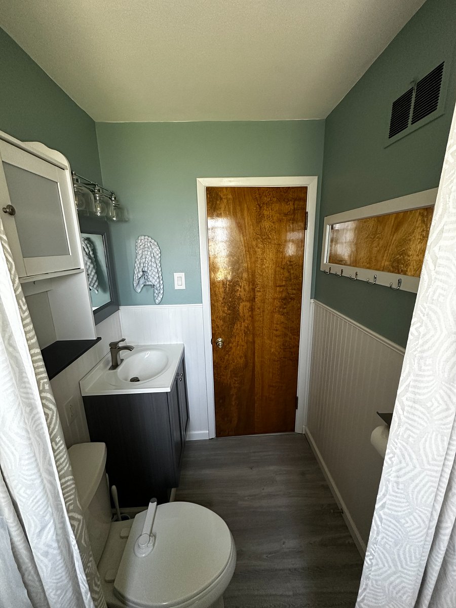 Bathroom with tub and shower. Medicine Cabinet and additional cabinet for storage.