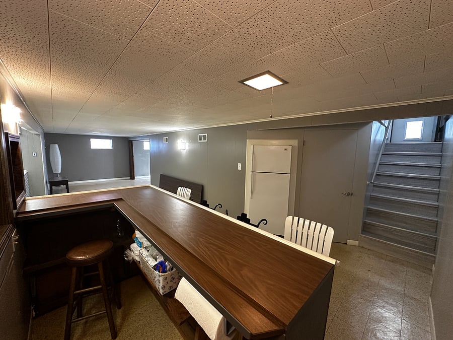 Finished Downstairs. 2nd refrigerator. Bar. Table. Lamps. Desk with chair. Lots of storage!