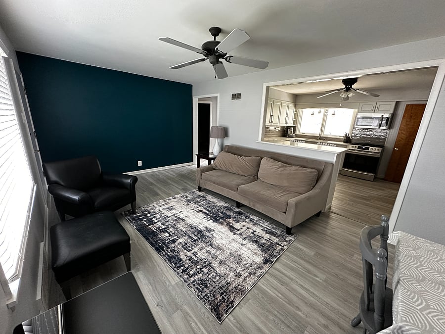Living Room. Couch, chair, ottoman, Smart TV, small table with 4 chairs.
