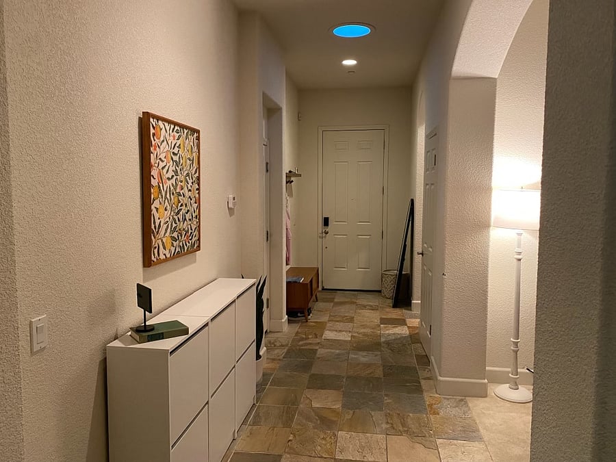 The entryway has plenty of storage to leave your shoes, coats, bags at.
