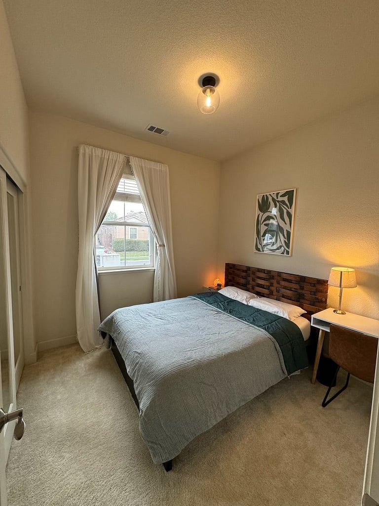 2nd bed with a queen sized bed and desk.