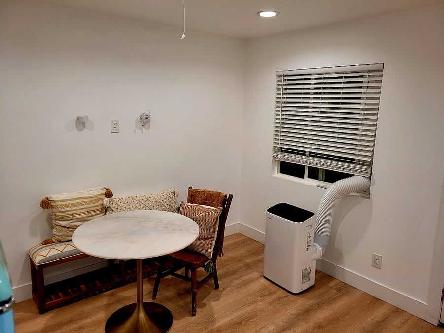 Dining and seating area in kitchen. Window looks out onto back patio and back yard.
