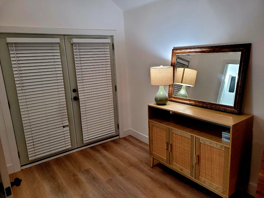 In-swing French doors open to front entryway. Hutch has several shelves for storing clothes.