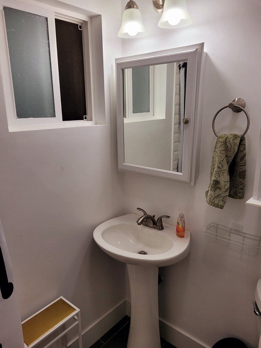Pedestal sink with bathroom window for ventilation. Bathroom also has HVAC for additional air circulation.