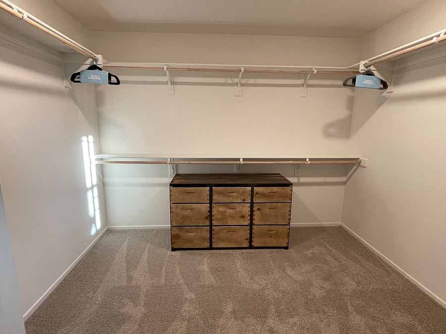 Primary bedroom walk-in closet
his & her side.
Custom dresser made by TheCratePeople
