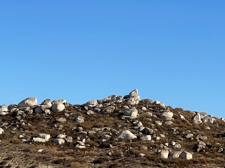 hillside view at major cross streets.
lovely large boulders!