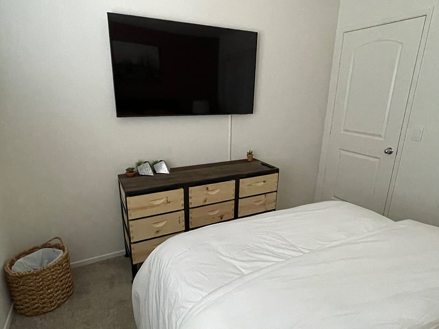 grammas wall mounted smart TV above dresser