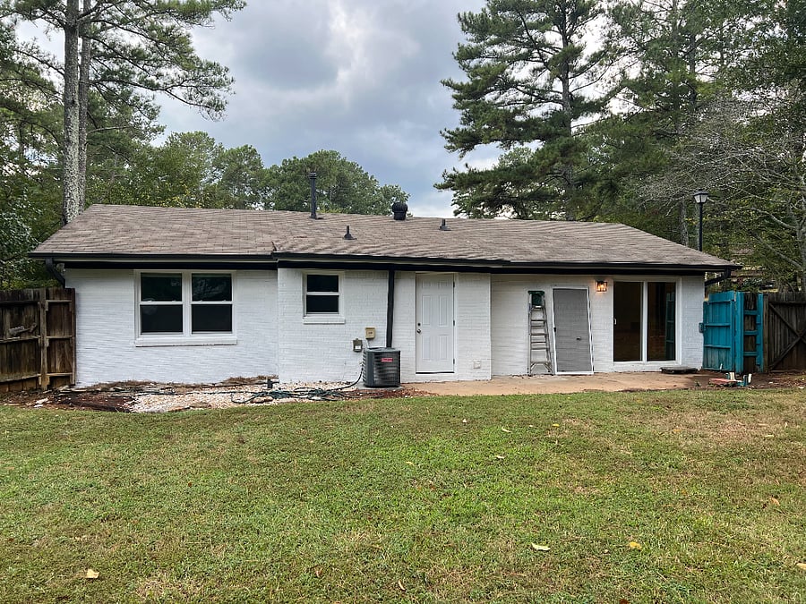View of back of home with huge completely fenced backyard