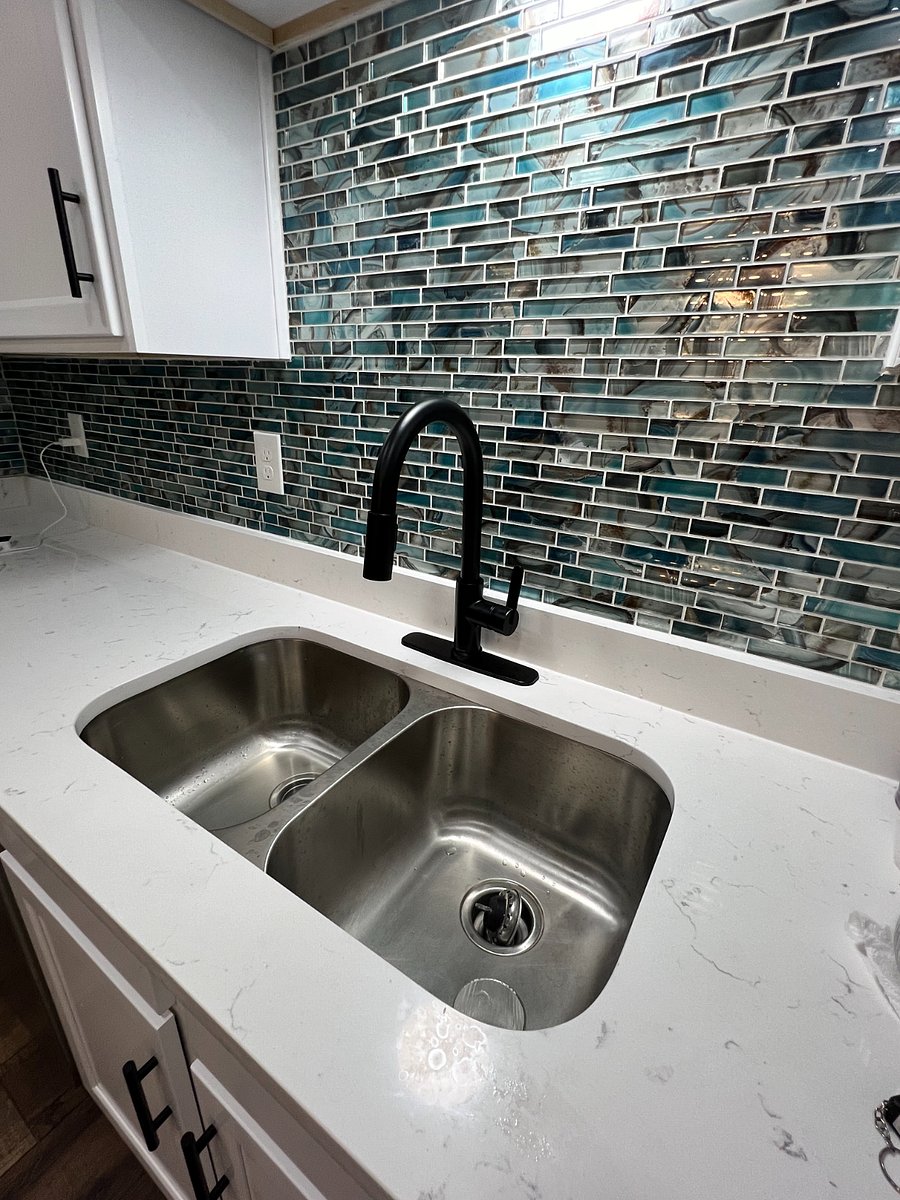 Brand new kitchen renovation with beautiful backsplash, Quartz countertops, and double sink