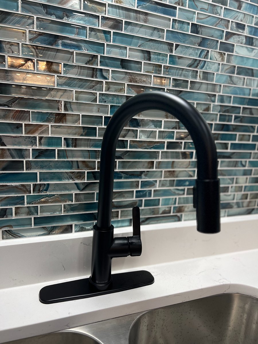 Brand new kitchen renovation with beautiful backsplash, Quartz countertops, double sink and oil bronzed faucet