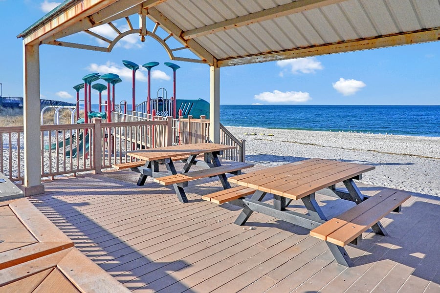 Nearby beach with picnic tables and a playground suitable for little ones.