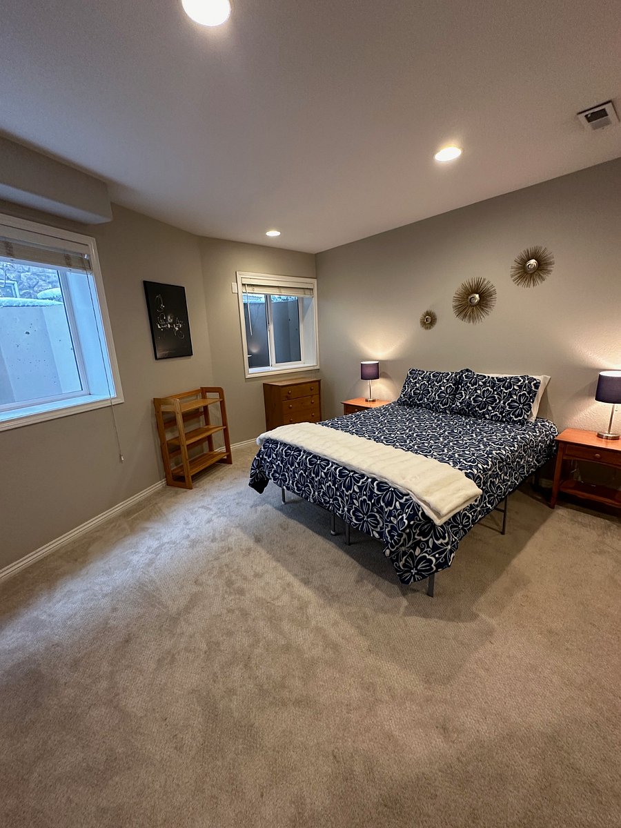 Spacious bedroom with two large windows for natural light