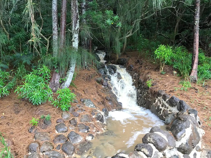 Small water fall behind property when it rains hard.