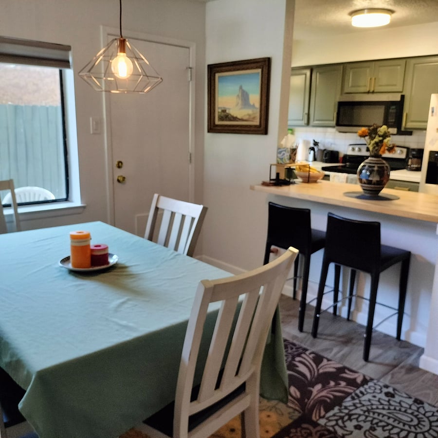 Full dining table with seating for six, and counter seating for two.