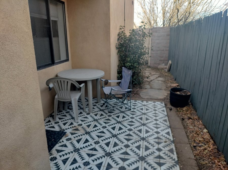 Side patio with table right outside the back door. Opening for pet door.