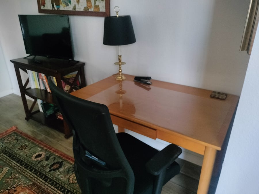 Smart t.v. and writing desk in den.