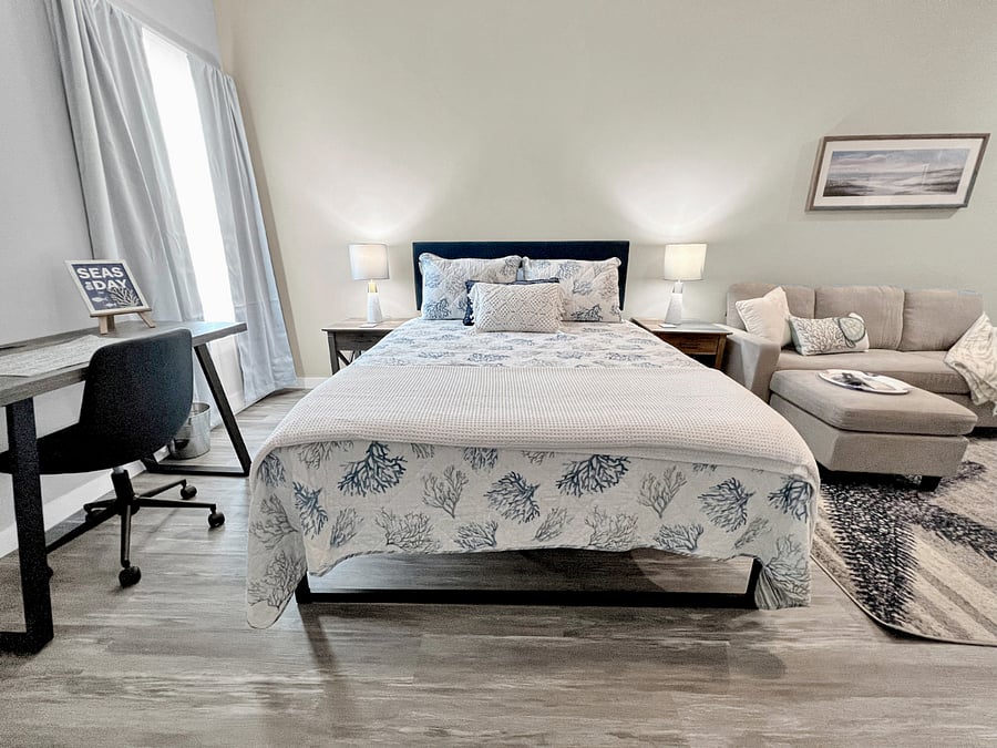 Entire room with a queen bed, seating area, kitchenette, dining area, smart TV, working space and a full bathroom! View from the entryway.