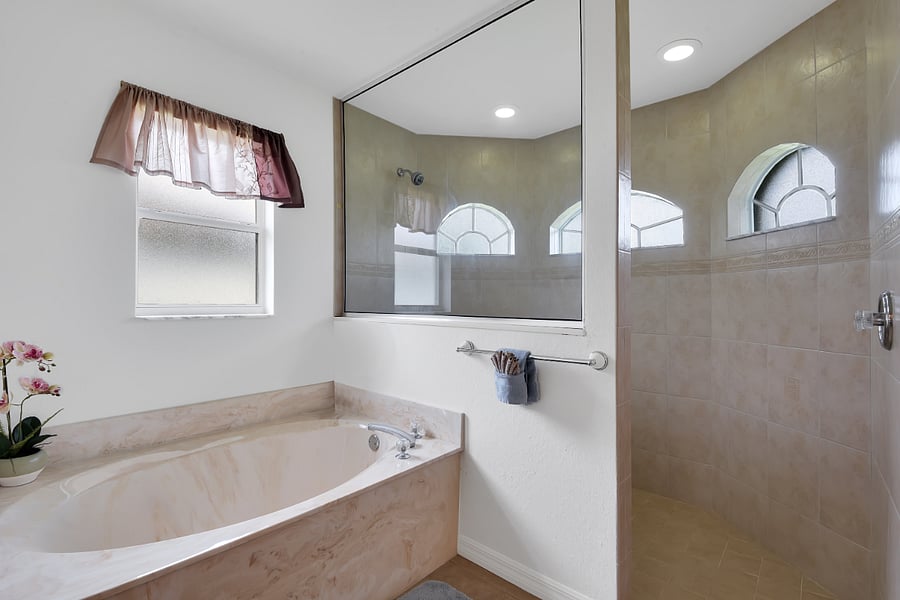 Attached luxury Master bathroom with a private tub and huge walk in shower.