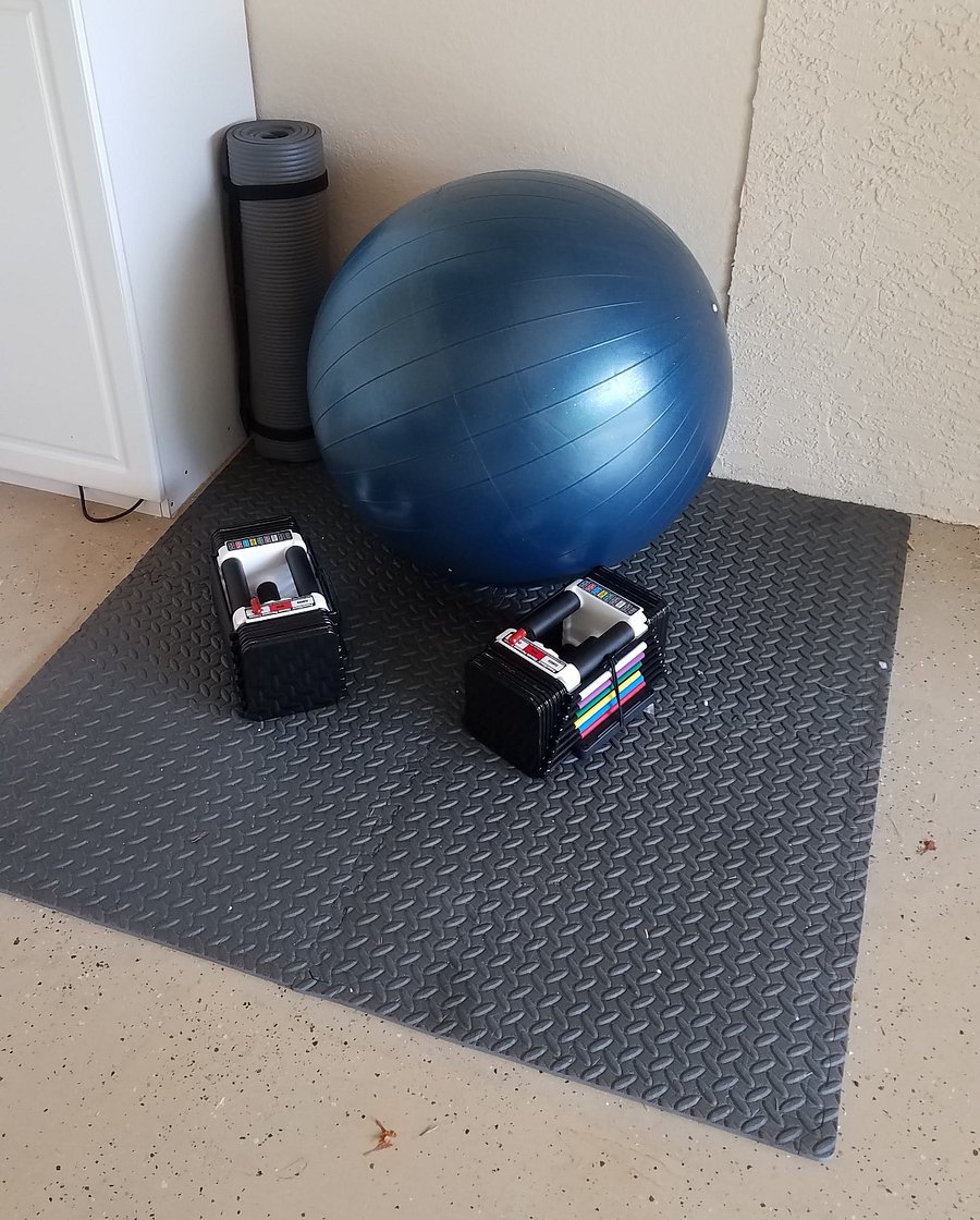 Exercise ball and Powerblock weights that adjust from 0-50 pounds.