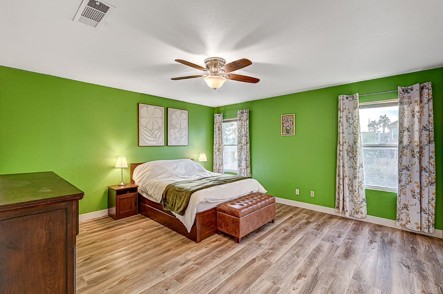 Master bedroom with a queen bed, additional storage capacity in the bench