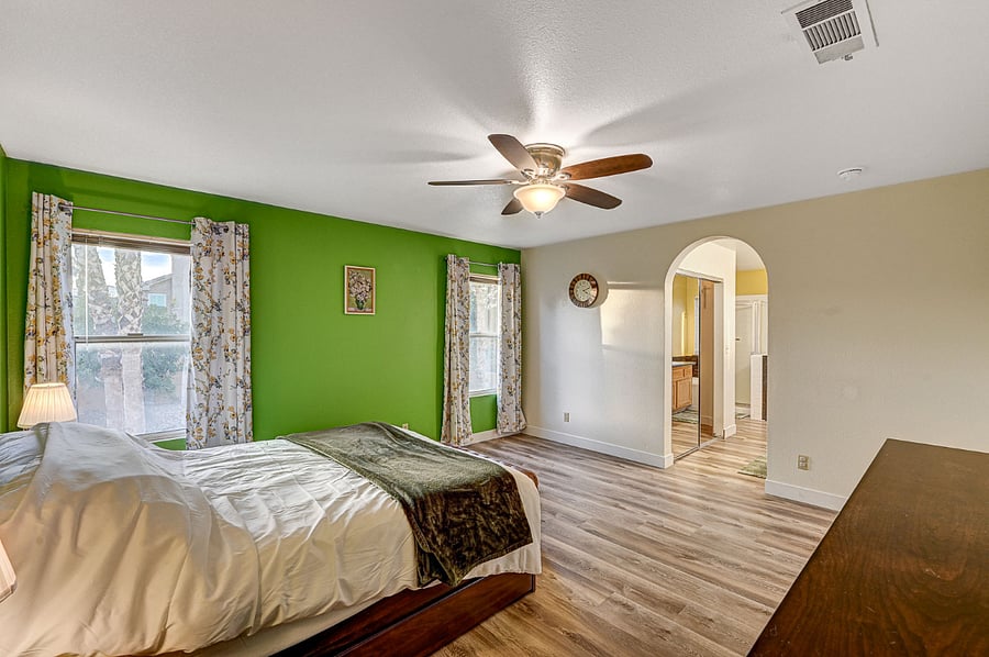 Master bedroom with a queen bed and a spacious bathroom and walk-in closet