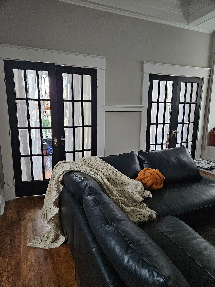 living room view to sunroom (furnished leather navy couch)