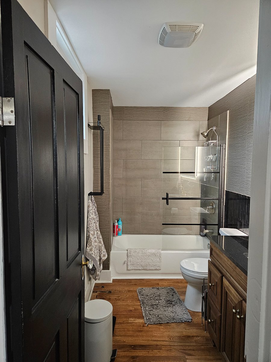 second floor bathroom granite counter. tile shower/tub, glass divider. led mirror