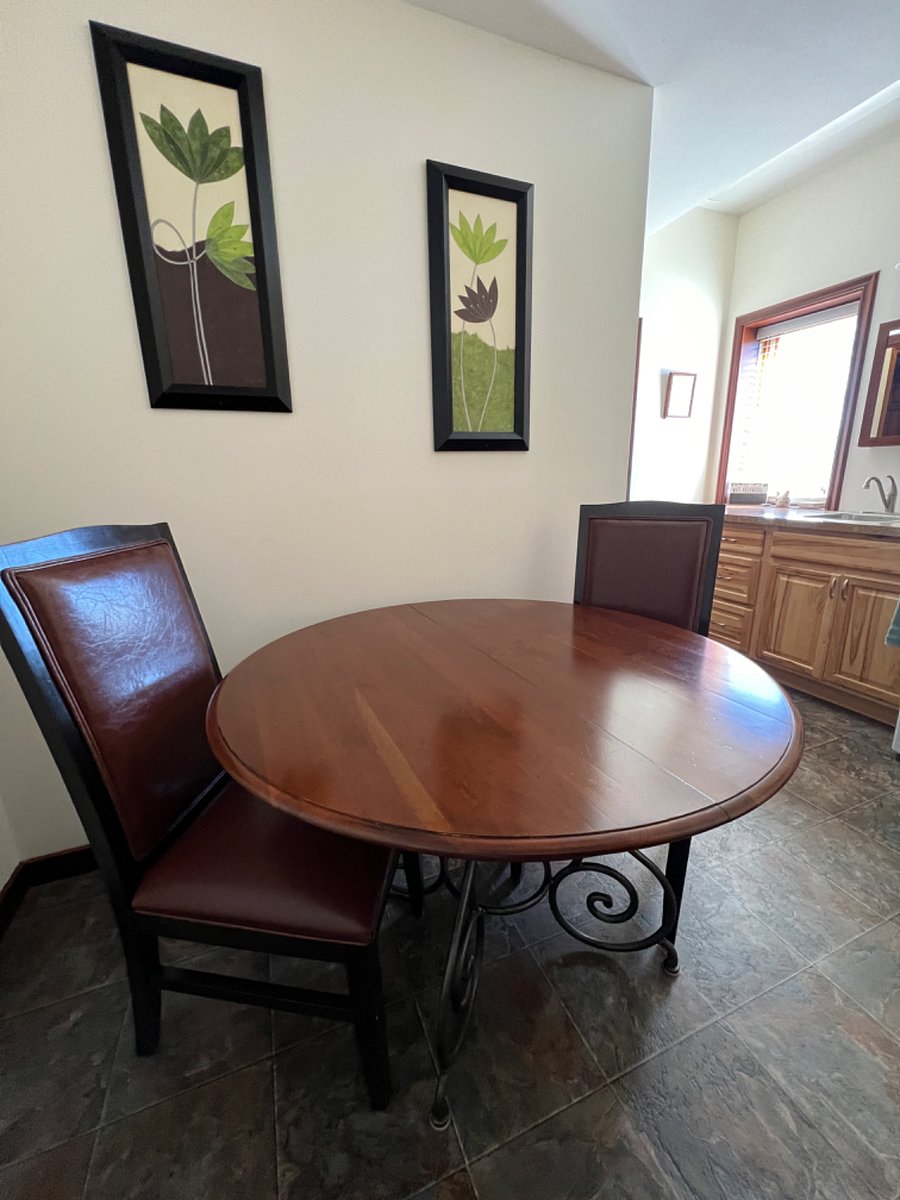 Private eating area with sink, cabinets with dinnerware and silverware, washer and dryer, 48' round table and 2 chairs, full size refrigerator with freezer, microwave, keurig coffee maker, electric water kettle, dinnerware, silverware and food pantry.