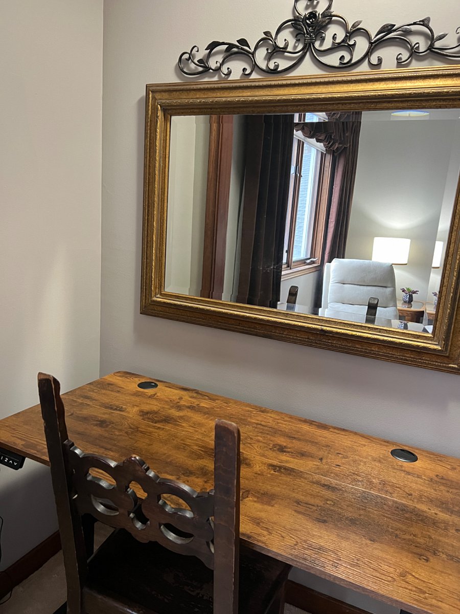 Private office area with 48" wide electric height adjustable desk to stand or sit when using.