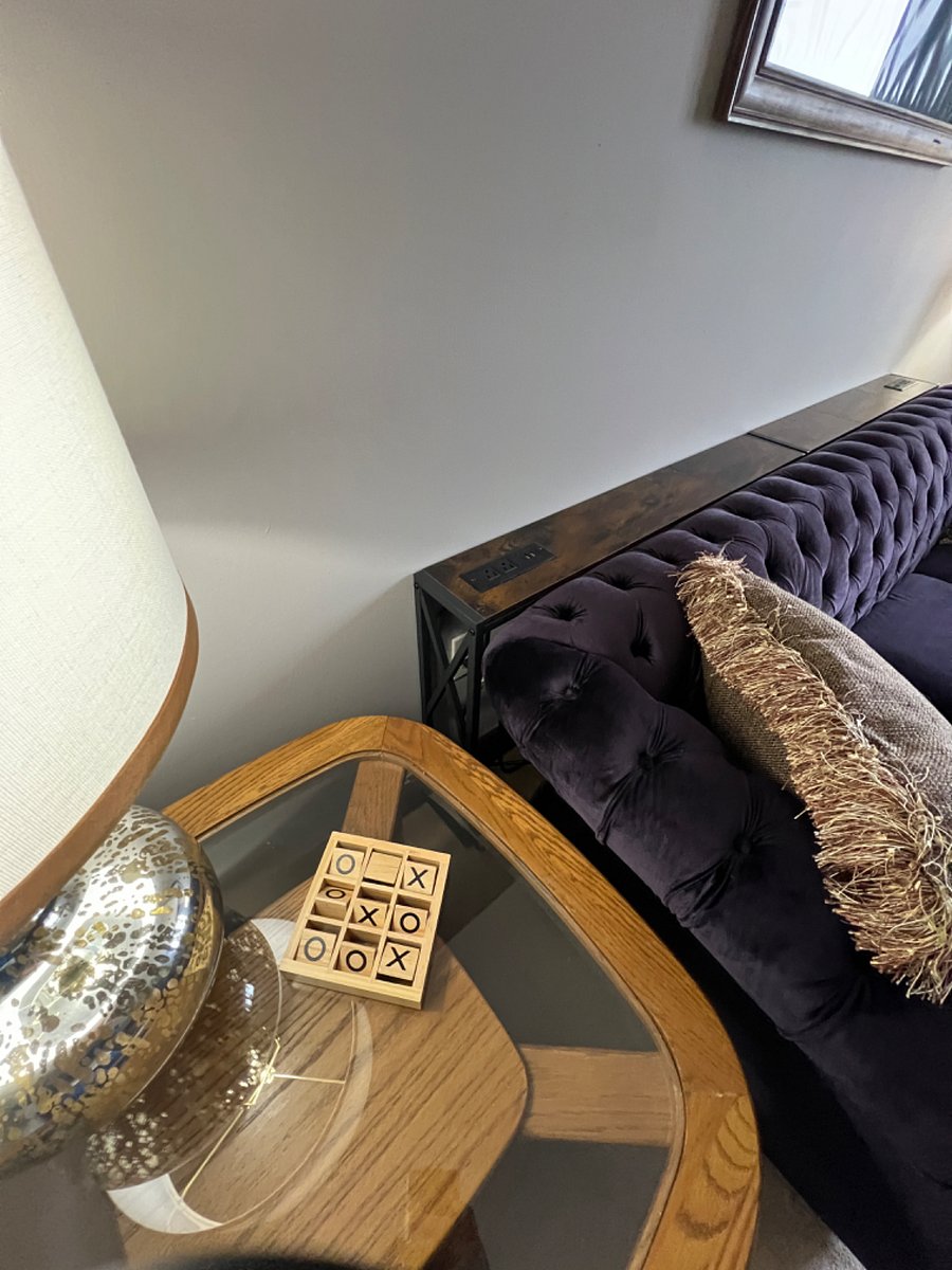 Sofa table in private living room with two charging stations each with 2 outlets and 2 usb ports for ease of use for your phones, tablets, and computer.