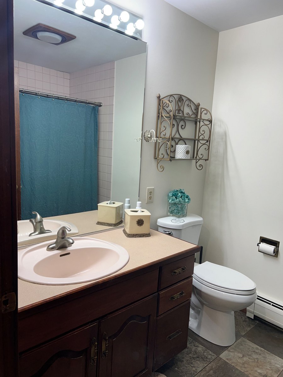 Private bathroom inside suite with full size shower with tub and sink with vanity.