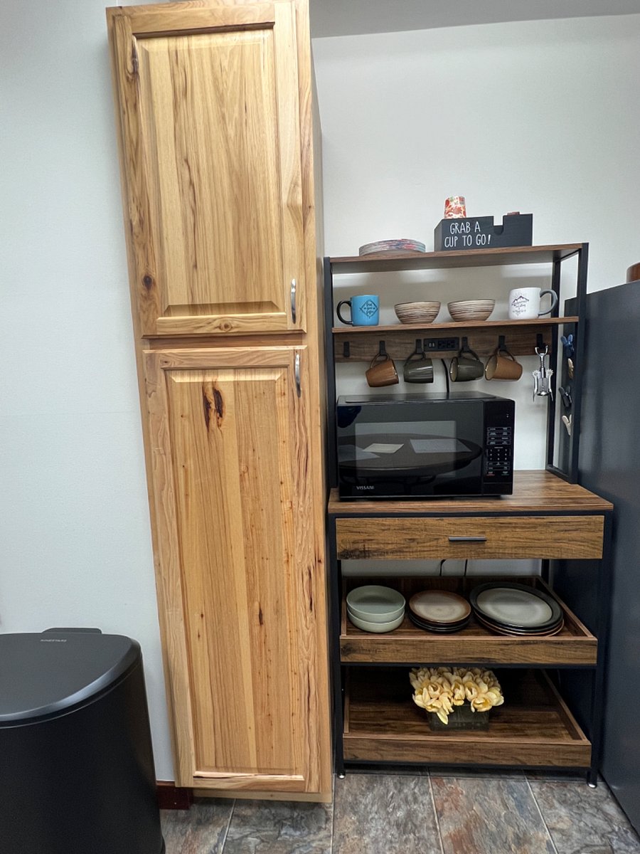 Private eating area inside suite with table and 2 chairs, full size refrigerator with freezer, microwave, keurig coffee maker, electric water kettle, dinnerware, silverware and food pantry.