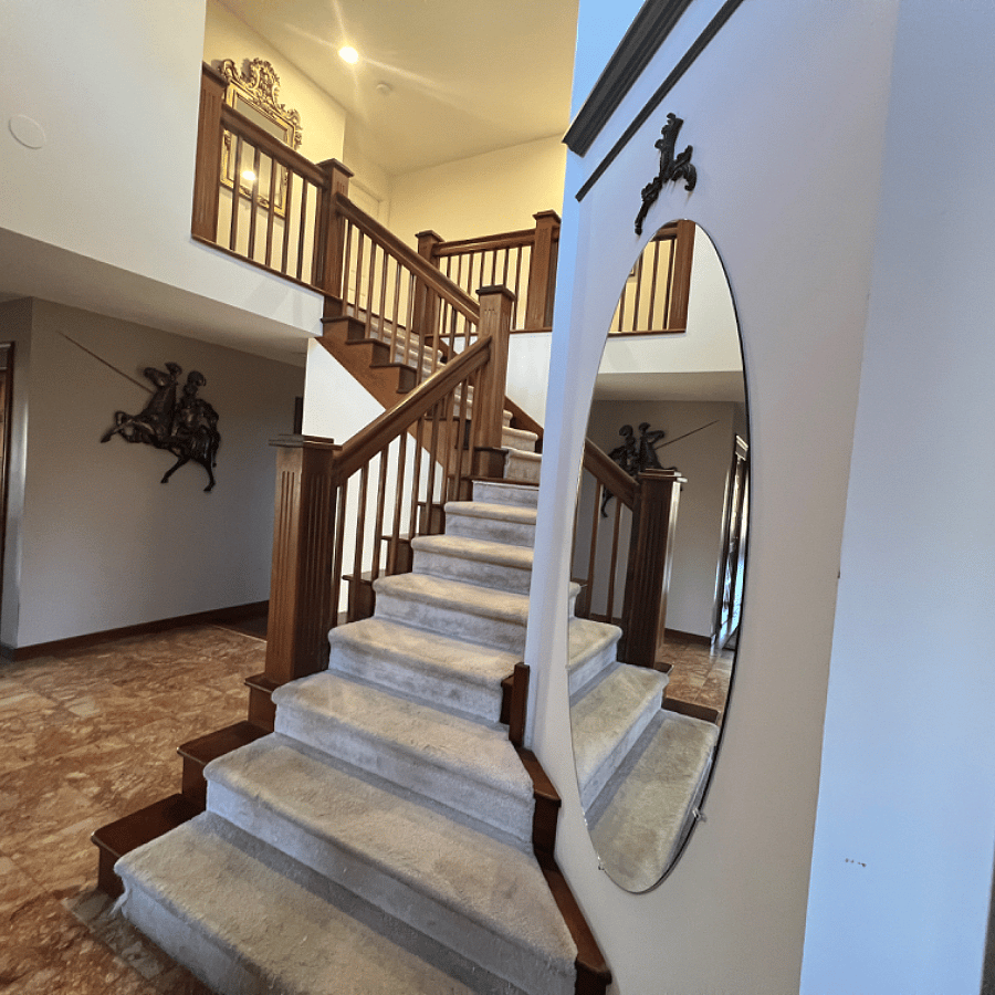 Shared foyer space stairway to private suite.