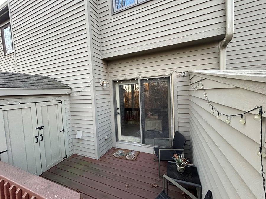 Private back patio with stairs to grass area