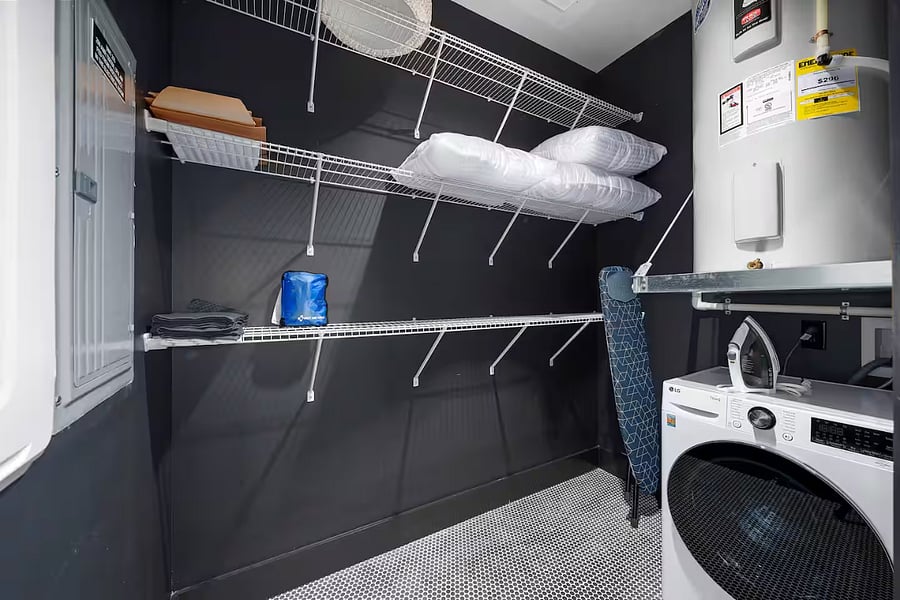 Laundry room. Washer/dryer with extra storage, pillows and supplies