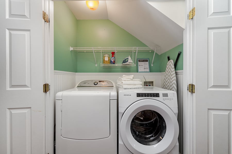 Full-sized washer and dryer, full-sized ironing board, iron, unscented detergent pods, and stain remover
