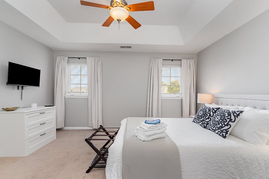 Master Bedroom with Smart TV. Brand new Queen sized bed and linens included with every stay. Enjoy the extra warm duvet, or swap to enjoy the summer quilt. Towels and Make-Up Eraser are included with every stay. Bedroom includes blinds and blackout curtains to eliminate light, great for shift workers and sensitive sleepers.